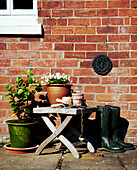 Gardening equipment and brick exterior of British home 