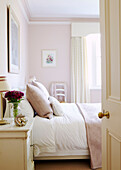 Pastel pink bedroom viewed through bedroom door