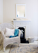 Painted cane chair at original fireplace in corner of room