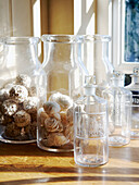 Biscuits in glass biscuit jar with decanters in sunlight