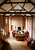 Sitting room with high ceiling and beams in renovated barn