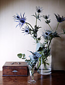 Cut flowers and wooden jewellery box in country home