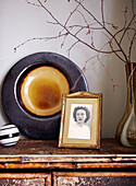 Family photograph and ceramic ornament on bamboo sideboard