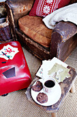 Brown leather armchair with Christmas cards coffee and biscuits