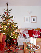 Christmas presents under tree with lit fairy lights