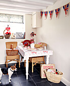 Wicker chairs and basket in kitchen with Union Jack bunting