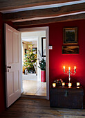 Lit candles in hallway of Christmas home