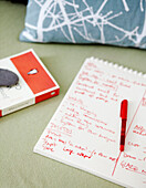 Handwritten list on notepad and book