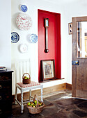 Entrance hallway with red recessed panel and decorative plates