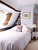 Singe bed in light blue attic conversion