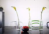 Single stem flowers with cherry tomatoes on modern work surface Newcastle dining room England UK