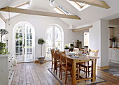 Arched patio doors in open plan dining room with beamed ceiling in City of Bath Somerset, England, UK
