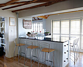 Breakfast bar with 'Danger Deep Mud' sign in kitchen of Hampshire home England UK