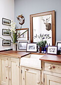 Belfast sink set in wooden surround with mounted animal heads in Durham home England UK