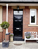Black front door on brick exterior porch Gateshead Tyne and Wear England UK