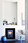 Recessed alcove above woodburner in London family home UK