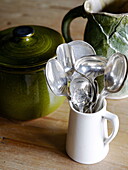 Silver spoons and green kitchenware dishes in Hexham kitchen Northumberland England UK
