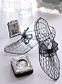 Wire mesh shoes with vintage silver alarm clock and framed picture in London home UK