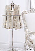 Gold embroidered jacket on suit stand in London home UK