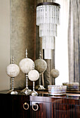 Marble ornaments and glass tiered shade on dark wood sideboard on classic London home, England, UK