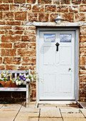 Grey front door of stone cottage in Oxfordshire, England, UK