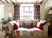 Two seater sofa in front of window in in Oxfordshire farmhouse, England, UK