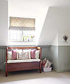 Bench seat at window with roman blind in Oxfordshire home, England, UK