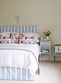 Co-ordinating headboard and valance in bedroom of Oxfordshire home, England, UK