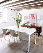 Table for six with vintage sideboard in contemporary Oxfordshire cottage, England, UK