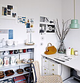Green pendant light in workroom with shelving and moodboard in Bussum home, near Amsterdam, Netherlands