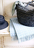 Blue shopping bag and hat with spotty blanket on antique bench seat, Oxfordshire, England, UK