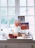 Christmas cards and candles on sideboard at window of Derbyshire farmhouse England UK