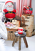 Hot drink on a side stool in a childs room with a cuddly Santa Derbyshire farmhouse England UK