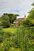Garden exterior of detached Surrey farmhouse England UK