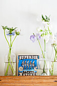 Cut flowers in vases and vintage safety matches in Surrey farmhouse England UK