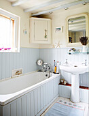 Light blue and cream panelled bathroom in Surrey farmhouse England UK