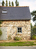 Rustic stone schoolhouse conversion in Brittany France