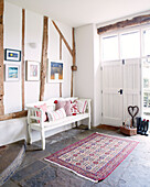 Painted bench seat in flagstone entrance of Nottinghamshire barn conversion England UK