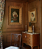 Gilt framed artwork in corner of panelled dining room traditional country house Welsh borders UK