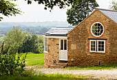 Stone exterior with porthole window rural Oxfordshire country house England UK
