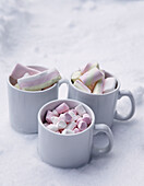 Marshmallows in cups in snow, St Anton, Tyrol, Austria