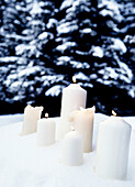 Lit candles in snow, St Anton, Tyrol, Austria