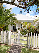 White picket fence surrounding Warkworth bungalow Auckland North Island New Zealand