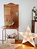 Stuffed pheasant on wooden side table with large star in Warkworth hallway Auckland North Island New Zealand