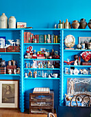 Collected homeware and ornaments on bright blue shelving in Auckland home North Island New Zealand