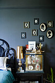 Vintage cameos above glass cabinet in grey bedroom of Auckland home North Island New Zealand