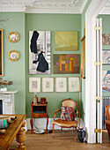 Konvexe Spiegel und Kunstwerke mit Sessel in einem Haus in Notting Hill, West London UK