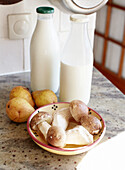 Mushrooms and pears with bottles of milk in Brittany kitchen France