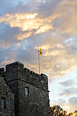 Flag on Northumbrian tower at dusk England UK