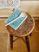 Wooden spoon with recipe book on carved stool in Hexham Northumberland UK